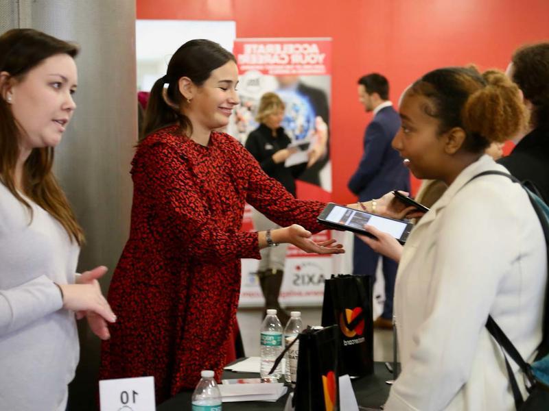 Young Black woman speaks with a white woman recruiter